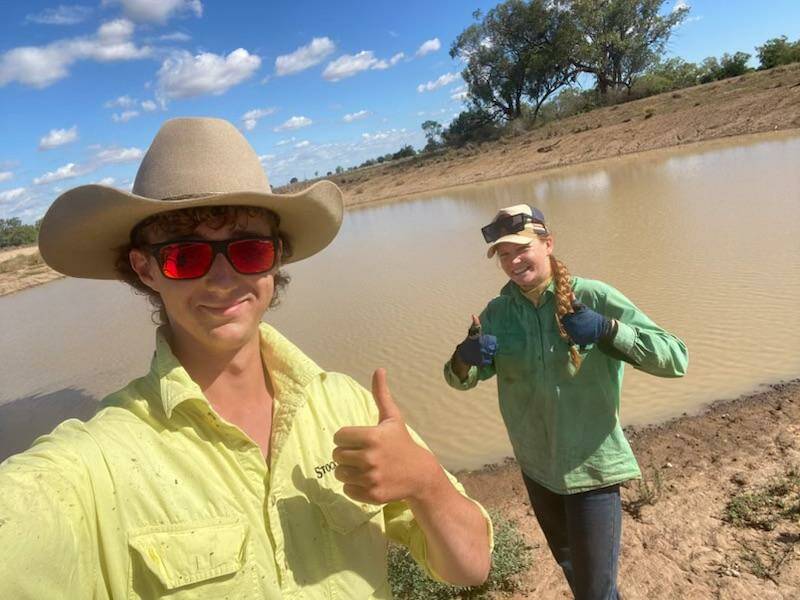 Ringers Oliver Clements and Eva Von Pein from Mullengudgery, Nyngan with the half full dam after 100mm fell. Picture by Manning Doughty.