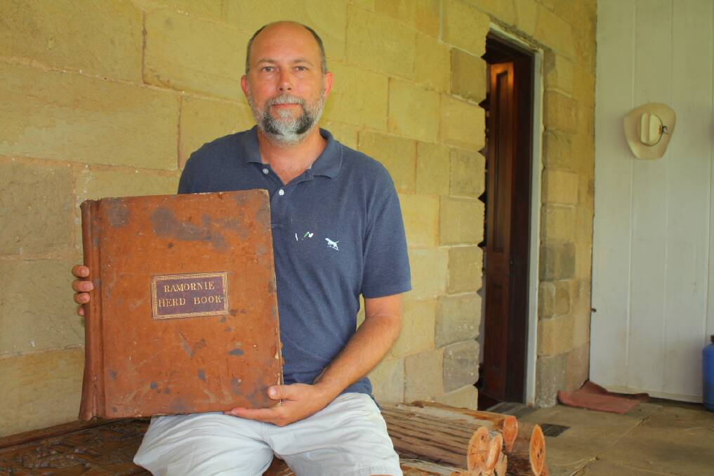 Bernard Holmes displays a historic herd book from one of the several cattle studs kept by the Tindals on Ramornie.
