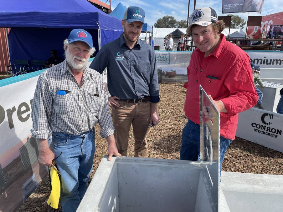 Graham and Stuart Luckie, Tooraweenah, inspected troughs at AgQuip with a plan to subdivide paddocks and improve water access for the new ones. With them is Haydon Rhodes, Conron Stockcrete, Grenfell.