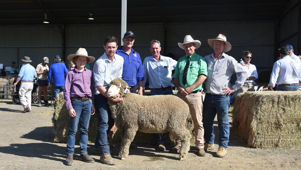 The top priced ram of the sale selling to Hallmark Pty Ltd, Wombat for $5250 with Daniel Mineham (14) and Patrick Davis, Demondrille Merinos, Matt Burgess, Hallmark Pty Ltd, Charile Davis, Demondrille Merinos, Rick Power, Nutrien Ag Solutions and Paddy Davis, Demondrille Merinos. Photo by Helen De Costa. 