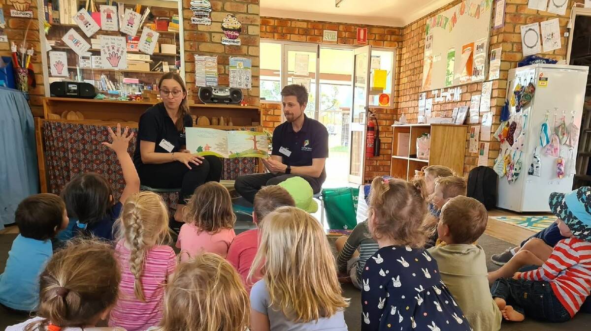 Royal Far West's Brianna Williamson and Chris Anderson read a story to school children in a bushfire-affected community. Picture supplied