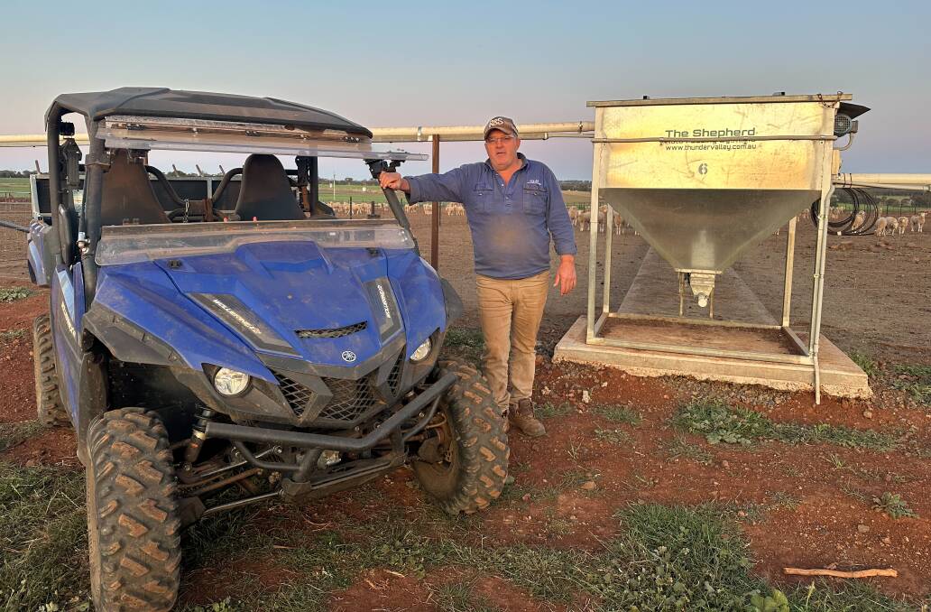 Hilton Barrett, Dubbo, with his sheep feeding setup, which includes his new The Shepherd automated feeders. Photo: Elka Devney