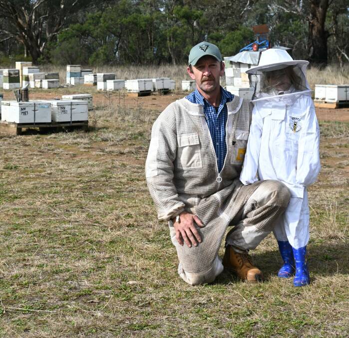 Michael Nonnenmacher, pictured with his six-year-old daughter Neci, is uncertain if he will be allowed to move his hives to Leeton to fulfil his pollination contracts. Picture by Denis Howard. 