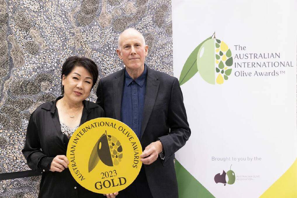 Wollundry Grove Olives producers Joo-Yee Lieu and Bruce Spinks with their gold award for their extra virgin olive oil. Picture supplied 