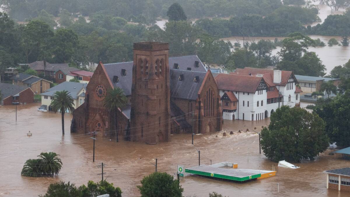 Lismore Catholic cathedral at the height of the February flood. Aboriginal lore said water could come this high but few believed it ever would. Now, reduced flood damage payouts to the local council are affecting community rebuild. Photo: ADF