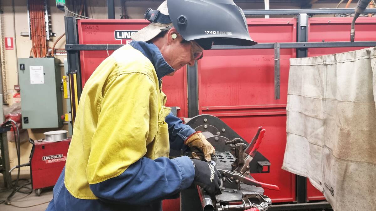 Mature-aged apprentice Donna Temple Smith preparing a weld at Boss Ag manufacturing facility at Inverell. Significant investment in vocational training will help drive greater productivity after billions in government funding was announced on Tuesday. Photo supplied.