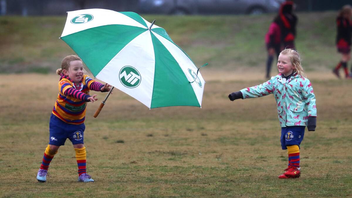 Enjoying the wet weather in Wagga Wagga were Emily Morrow 5, from Hay and Fleur Stalley 4, from Hillston who chase of wind swept umbrella during inclement weather. Wagga had over 30mm. Picture courtesy of Wagga Daily Advertiser.
