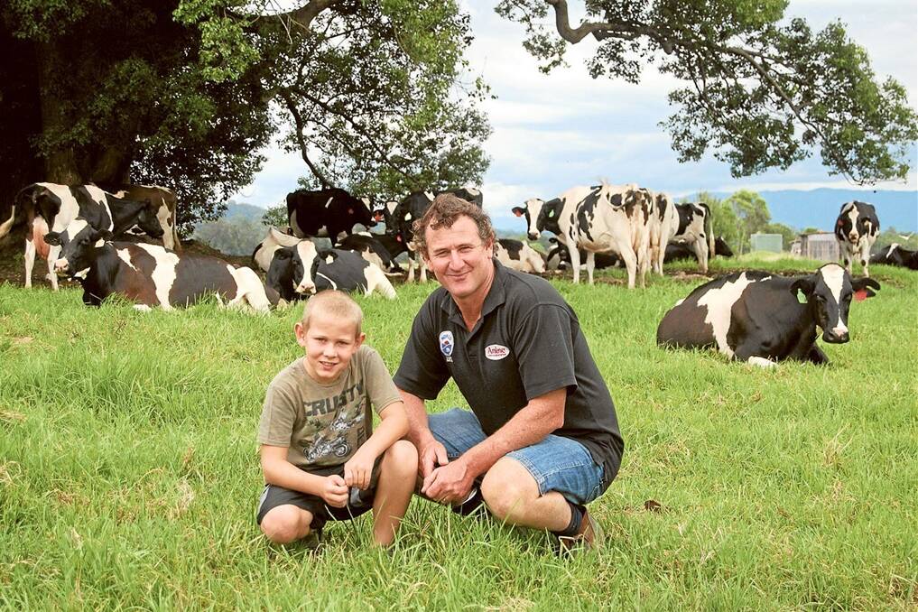 Mark Perry  with his son Josh and some of the family’s A2 Holstein herd.