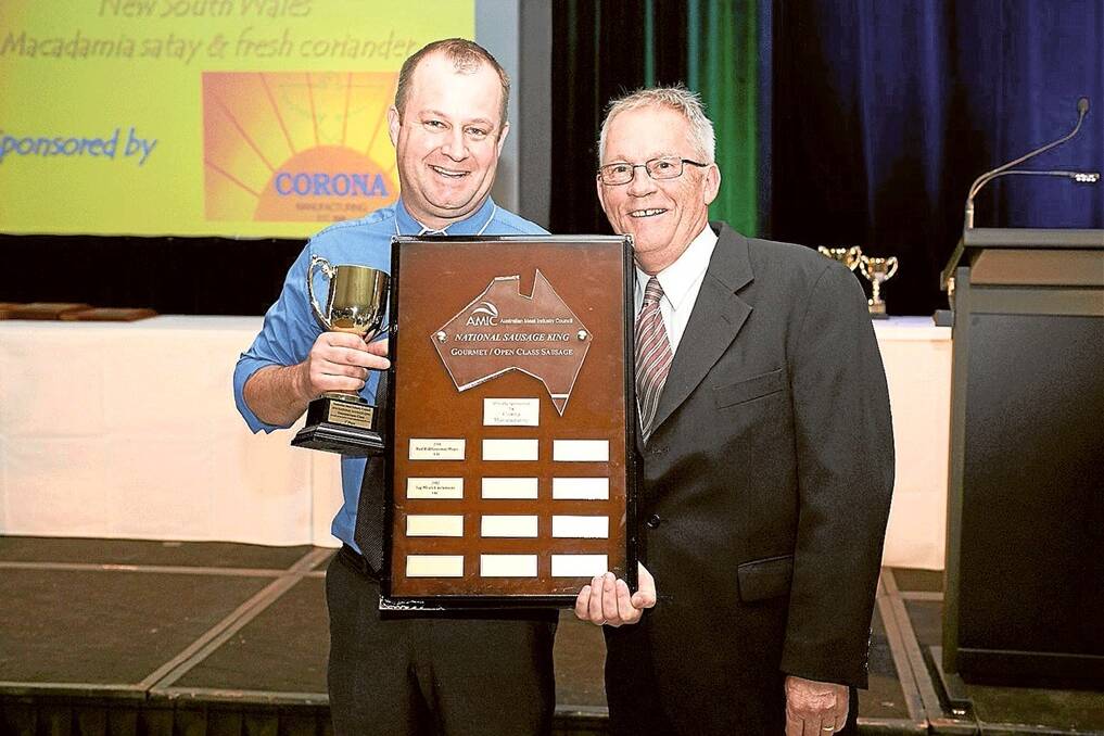 Nathan Alcock from Mountainside Meats receives his trophy for winning the gourmet/open category at the National Sausage King from Corona Manufacturing’s national distribution sales manager Keith Gridley.