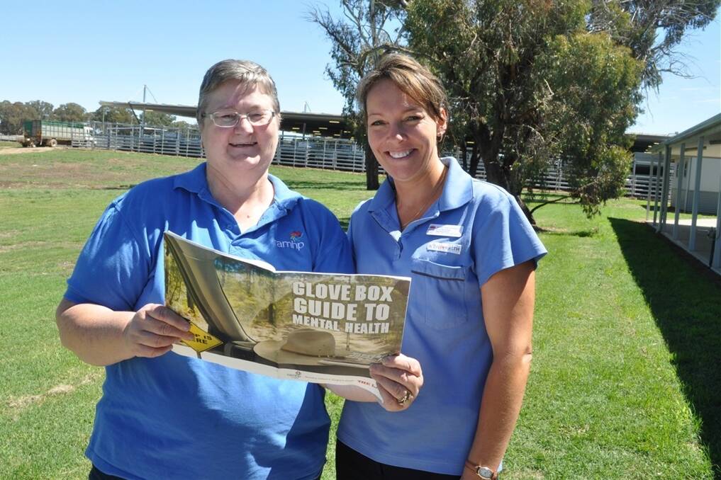 Rural Adversity Mental Health Program rural mental health consultant Di Gill, Condobolin and Kylie MacKillop, NSW Health, Blayney Primary and Community Health, Blayney, with The Land's Glove Box Guide to Mental Health