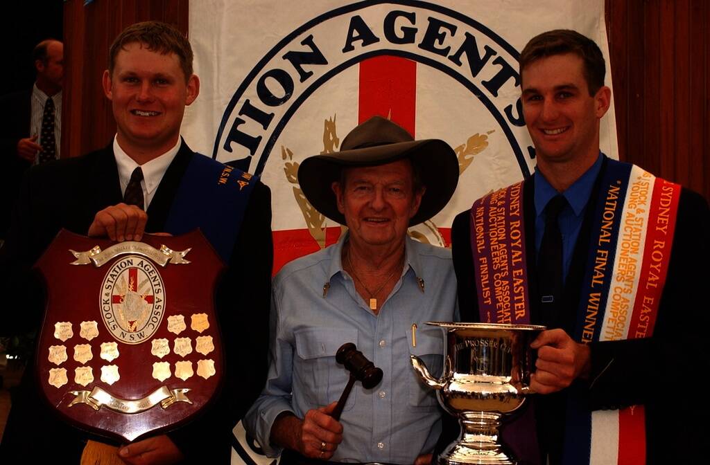 Country music legend Slim Dusty with the 2002 Young Auctioneers Competition winners Andrew Bickford, Glen Innes, and Innes Fahey, Grafton, after winning the State and national titles.