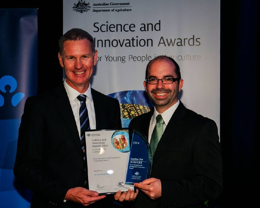 GRDC managing director John Harvey (left) presents Jonathan Plett from the University of Western Sydney with his GRDC-sponsored 2014 Science and Innovation Award for Young People in Agriculture. Photo: Steve Keough Photography