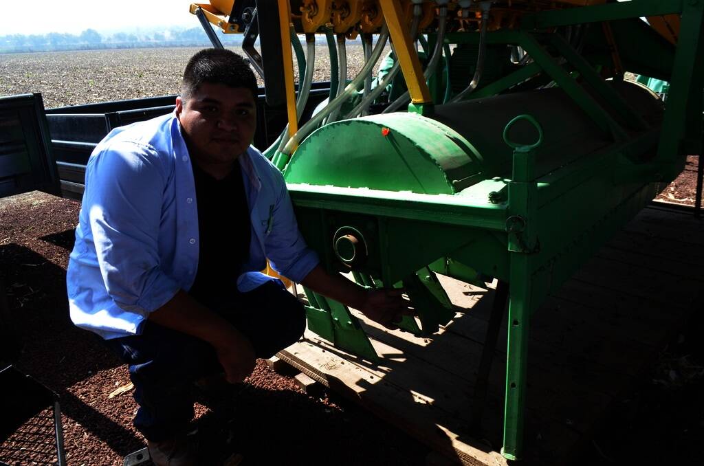 CIMMYT engineer Gabriel Martinez Perez with a conservation planter fitted with residue spreaders and narrow point tynes.